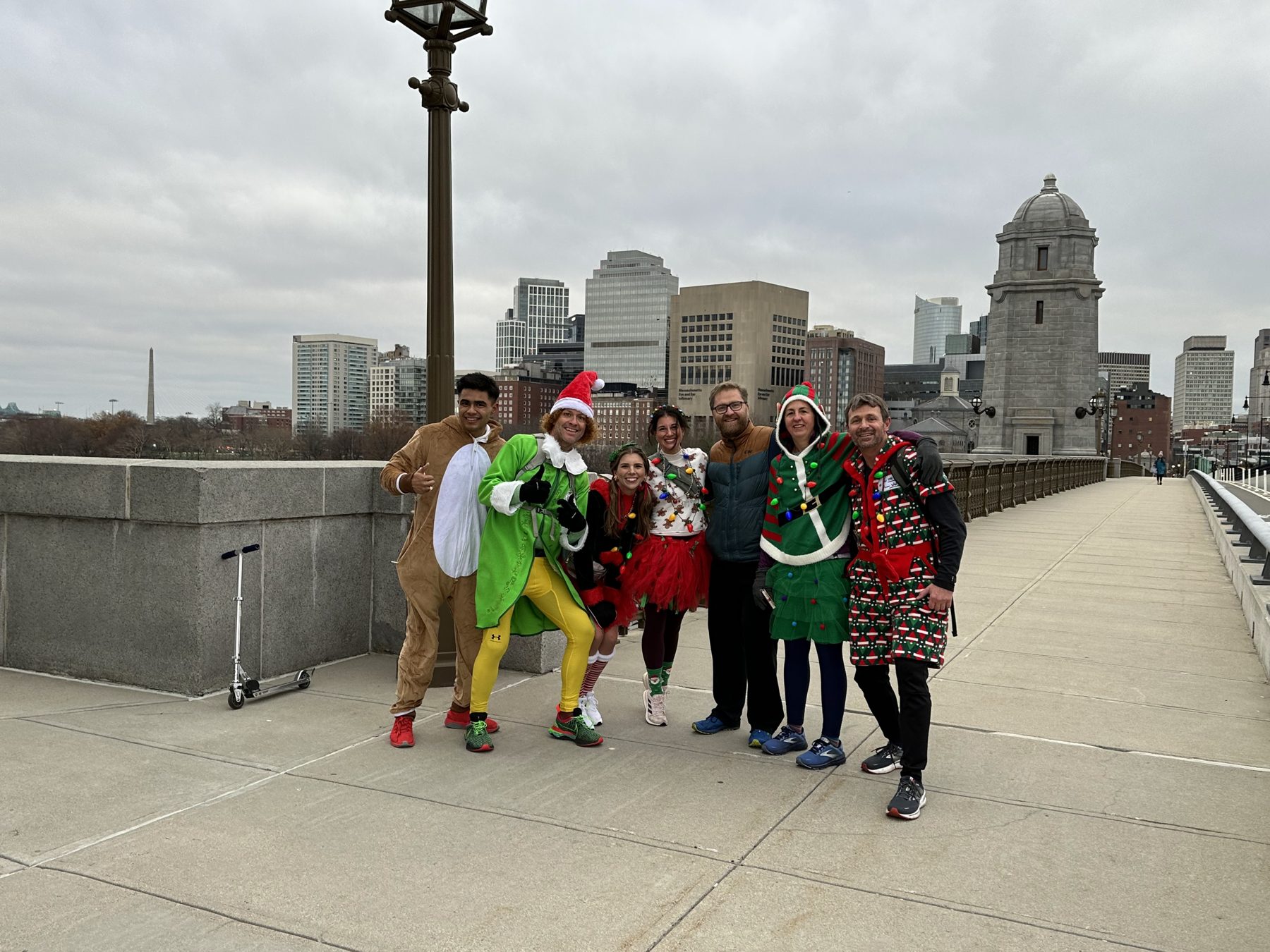 Crew in costumes on a bridge with the Boston skyline